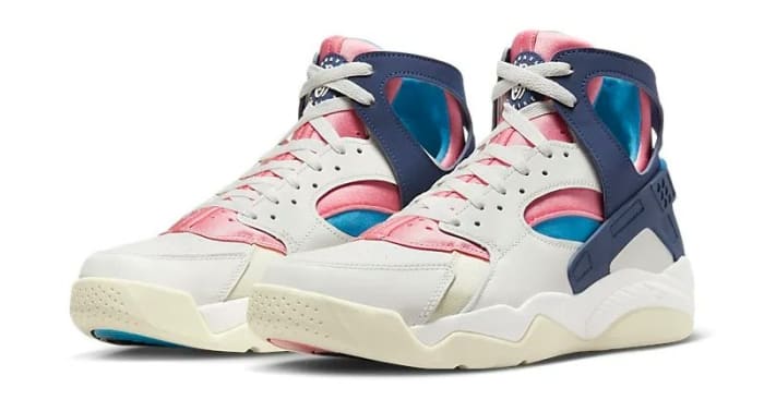 Side view of white, navy, and pink Nike sneakers.